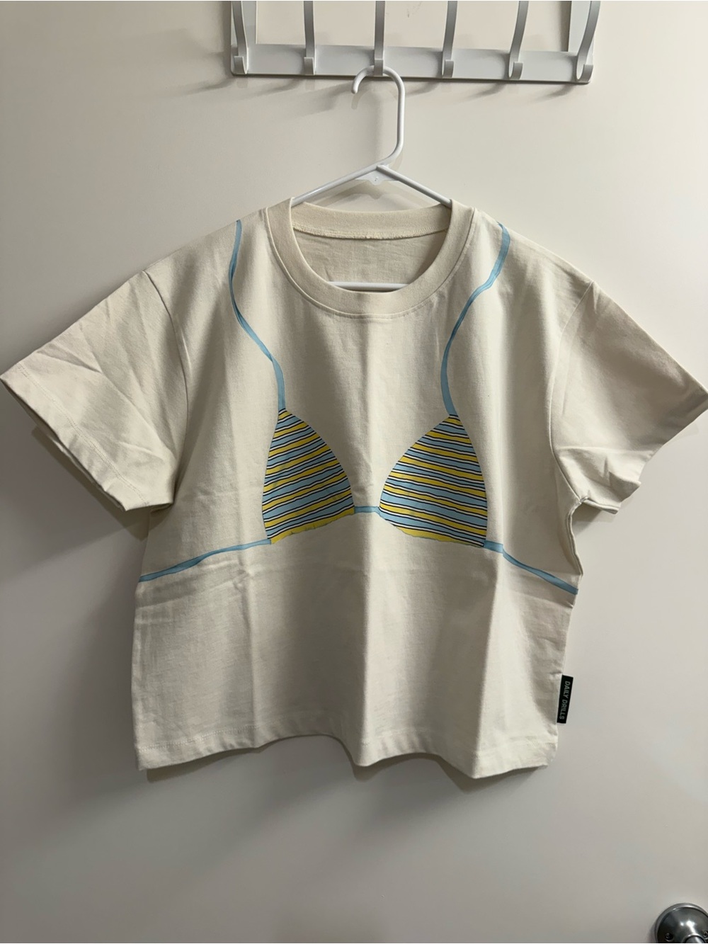 Daily Drills Cream Short Sleeve Tee with Blue & Yellow Bikini Graphic